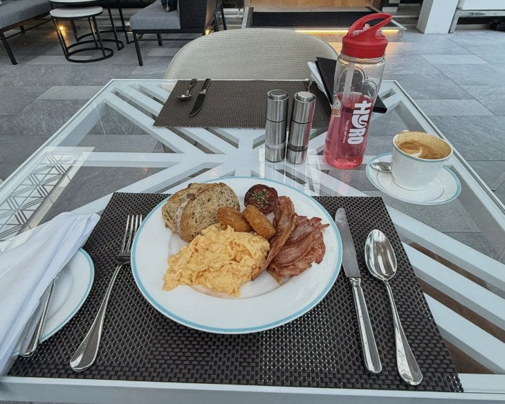 Hotel breakfast with a coffee and a Hyro bottle