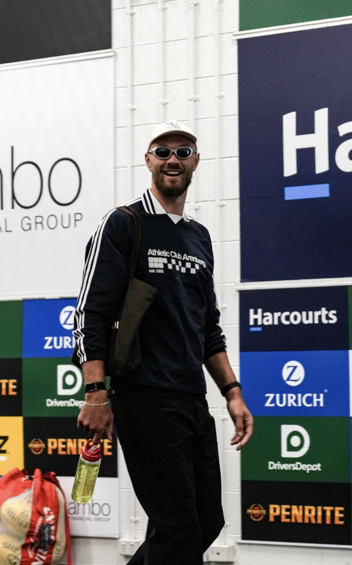 Max Gawn walking in with a Lemon Lime Hyro bottle