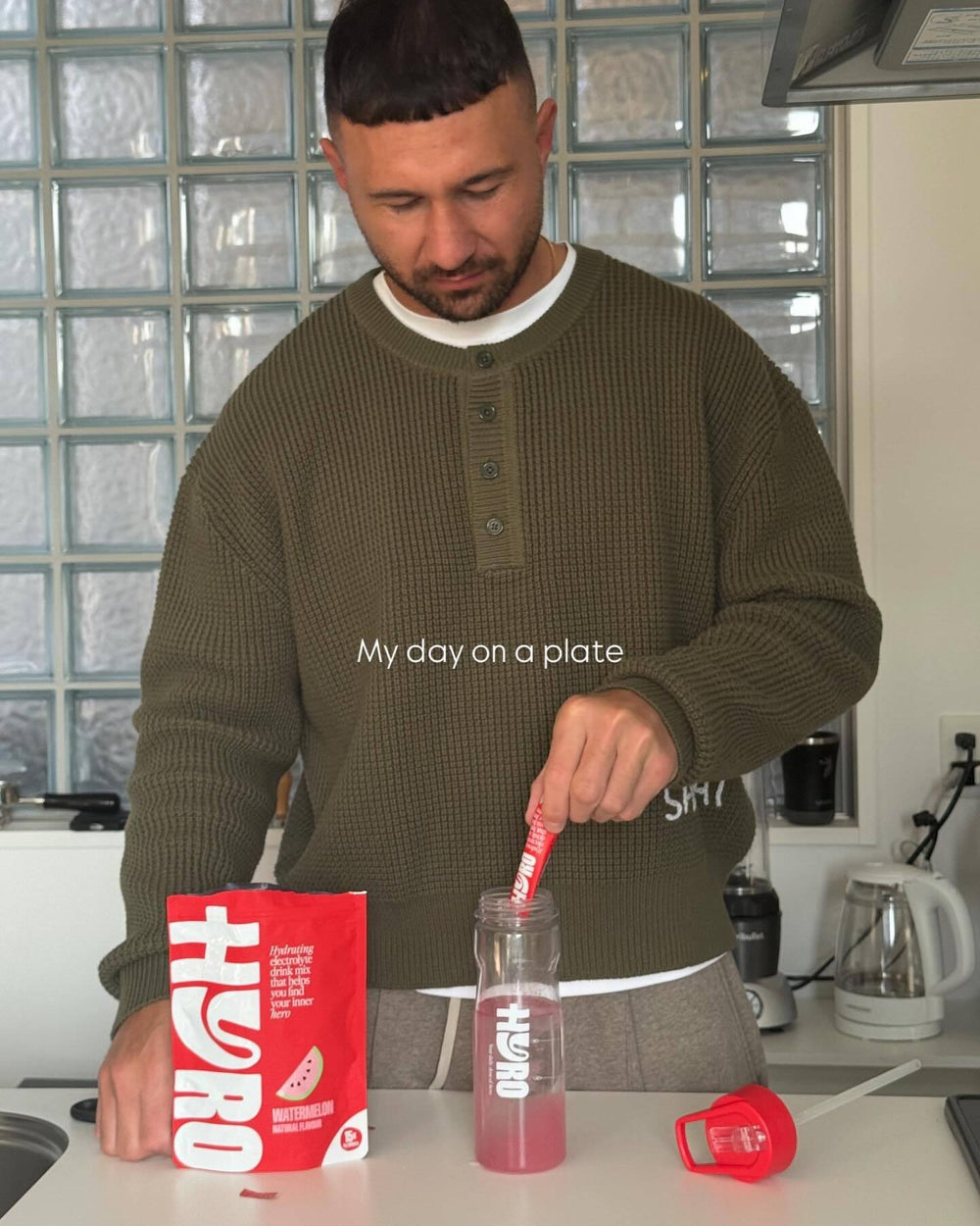 Quade Cooper giving the OK sign with a Hyro bottle