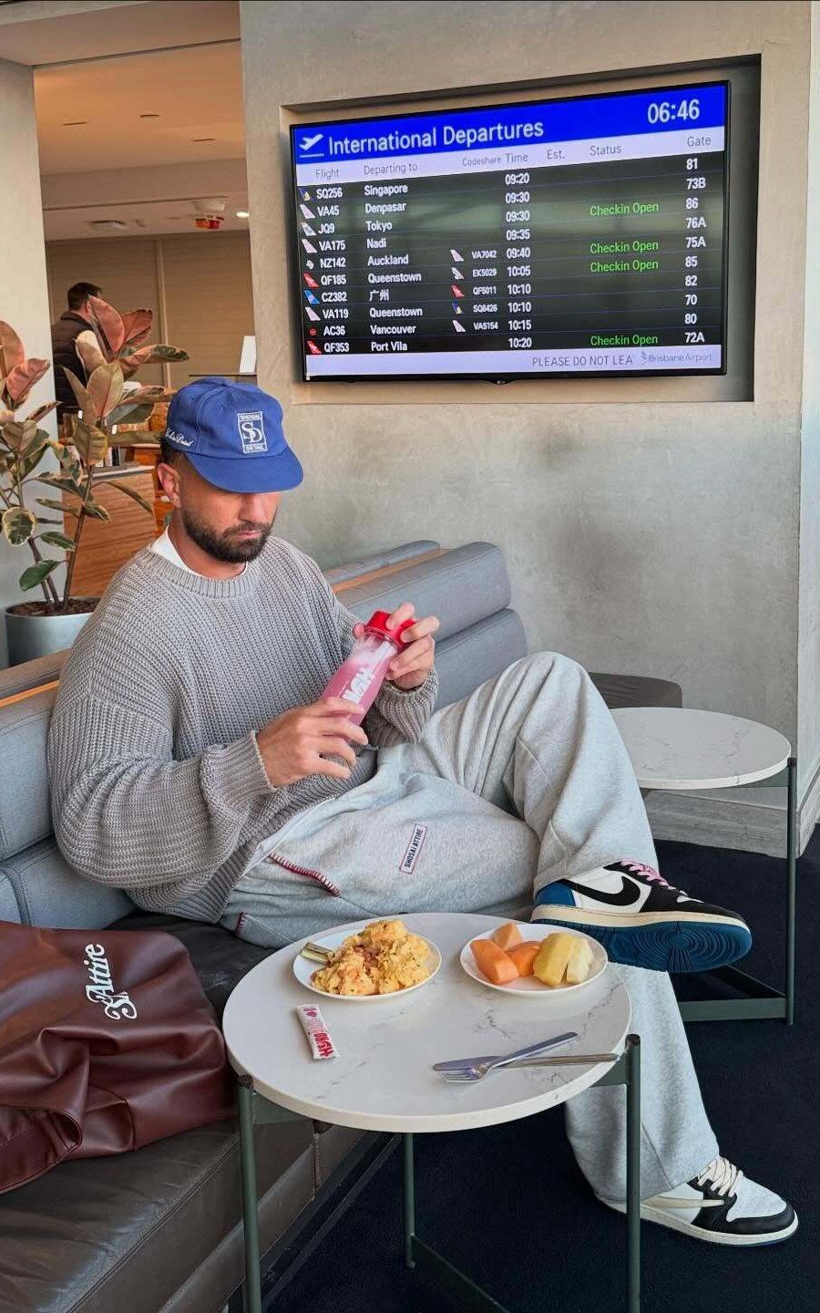 Quade Cooper drinking Hyro in an airport lounge