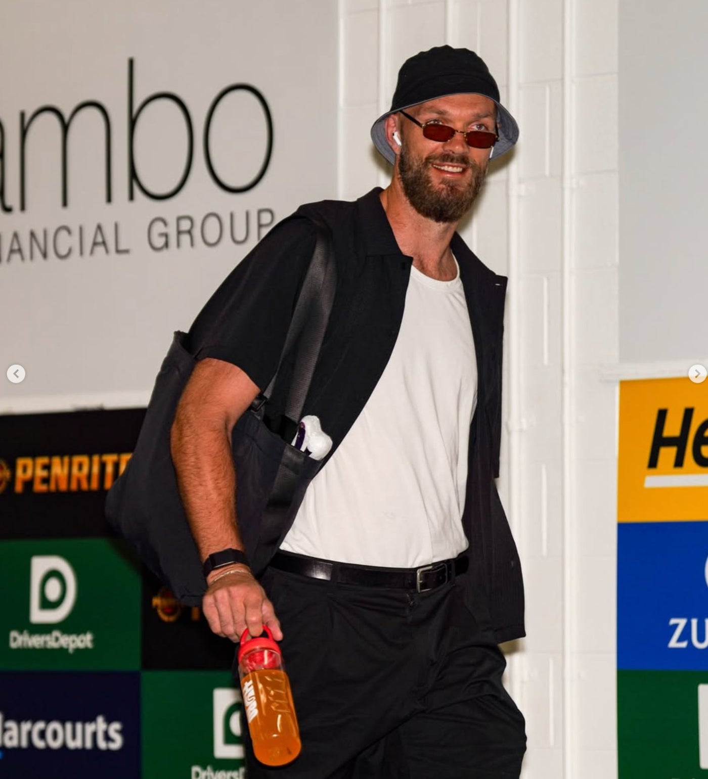 AFL star Max Gawn arriving at the ground carrying a Hyro bottle filled with orange-mango drink