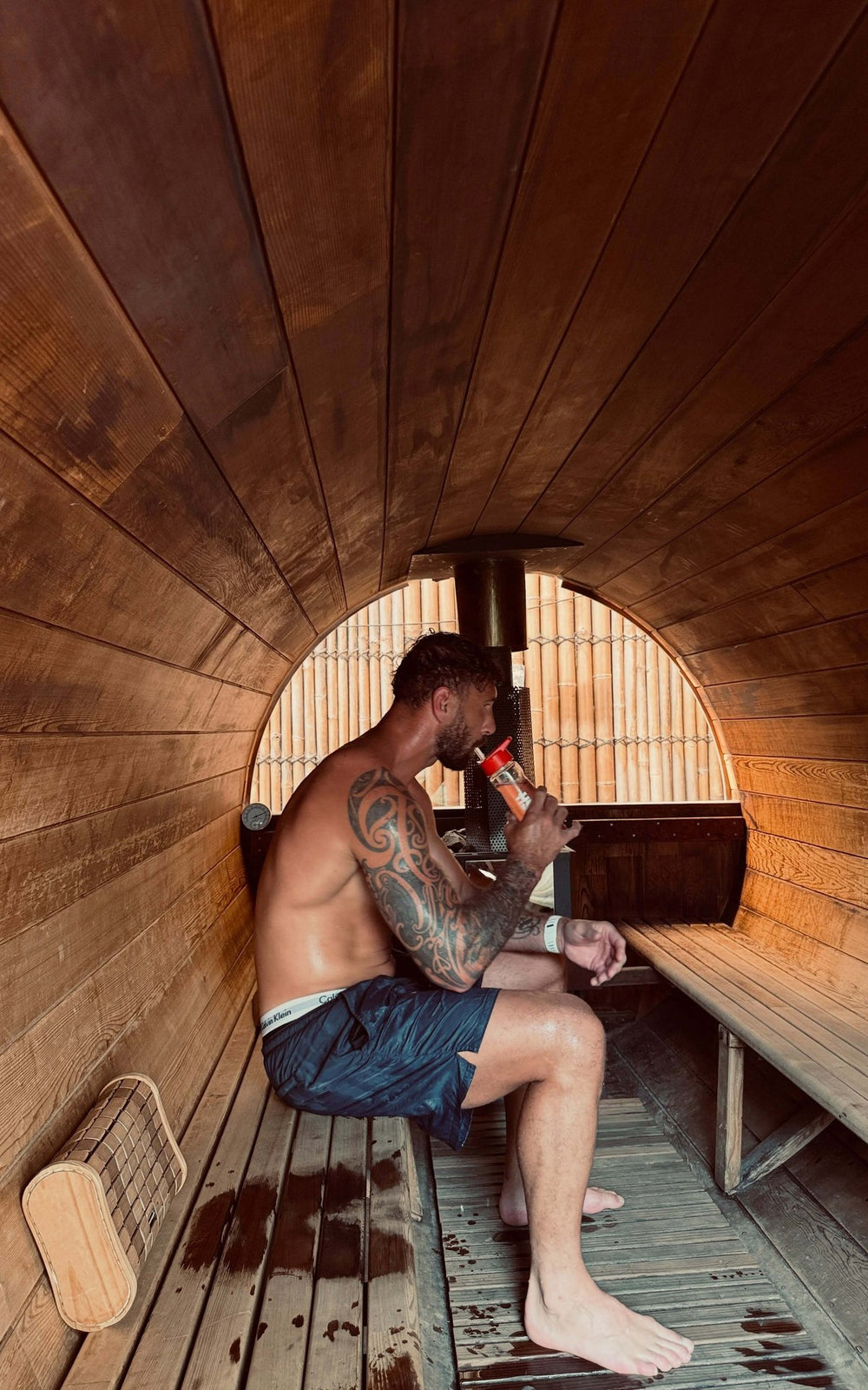 Quade Cooper drinking Hyro in a barrel sauna